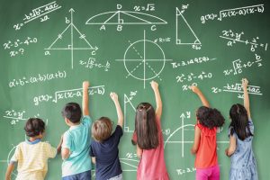school children drawing math icon on the chalkboard